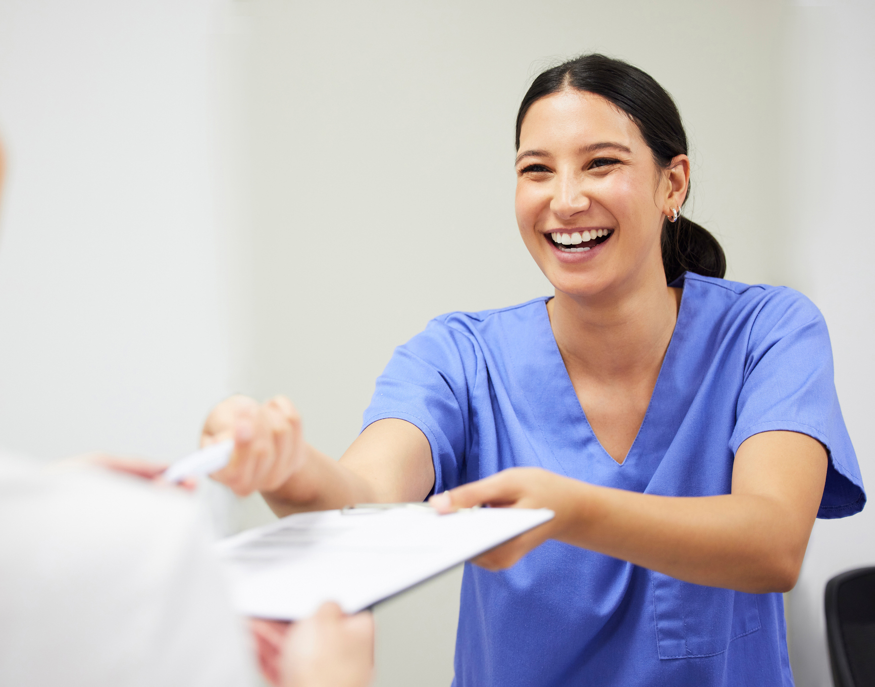 Shot of a patient and assistant interacting in a dentist office