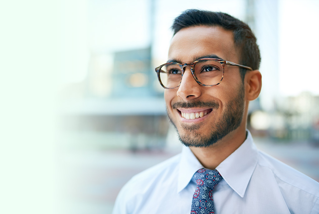 Portrait of a confident, happy business entrepreneur wearing fashionable tie and eyewear on his way to his next consultant meeting