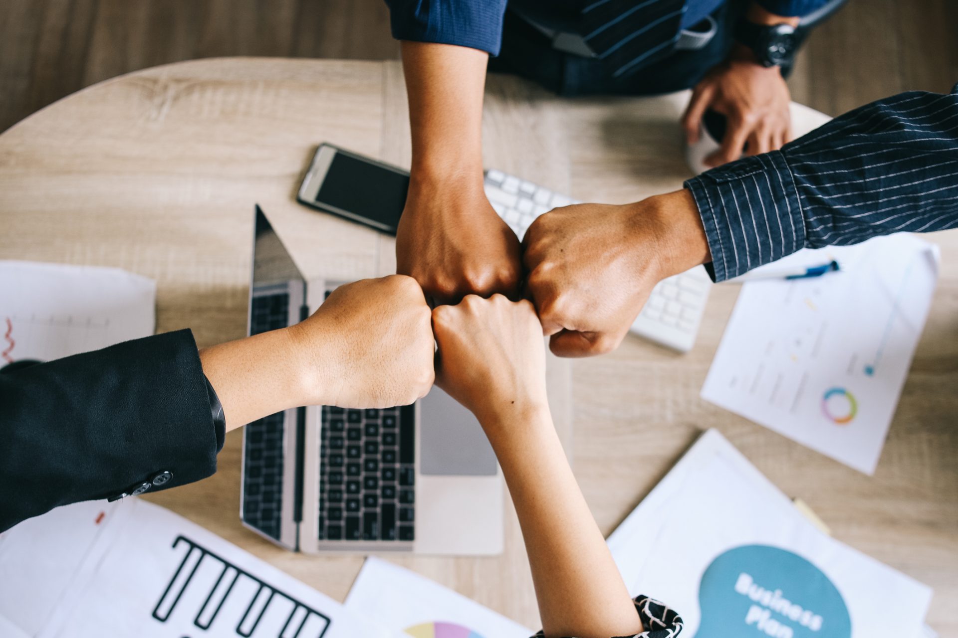 Businesss People Clenching Fist Together For Successful Business at The Office Meeting Desk